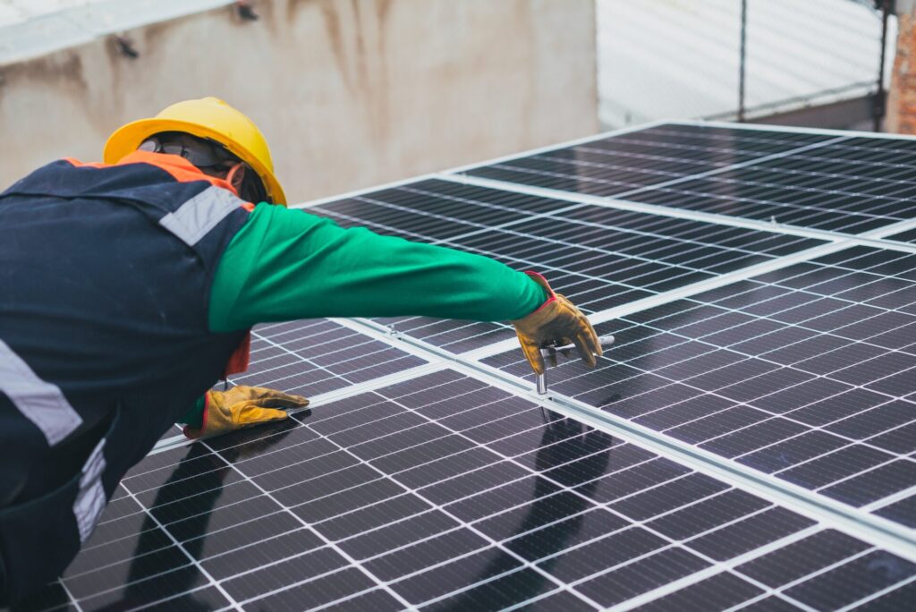 An image of a Solar Photovoltaic Installer / PV installer at work.