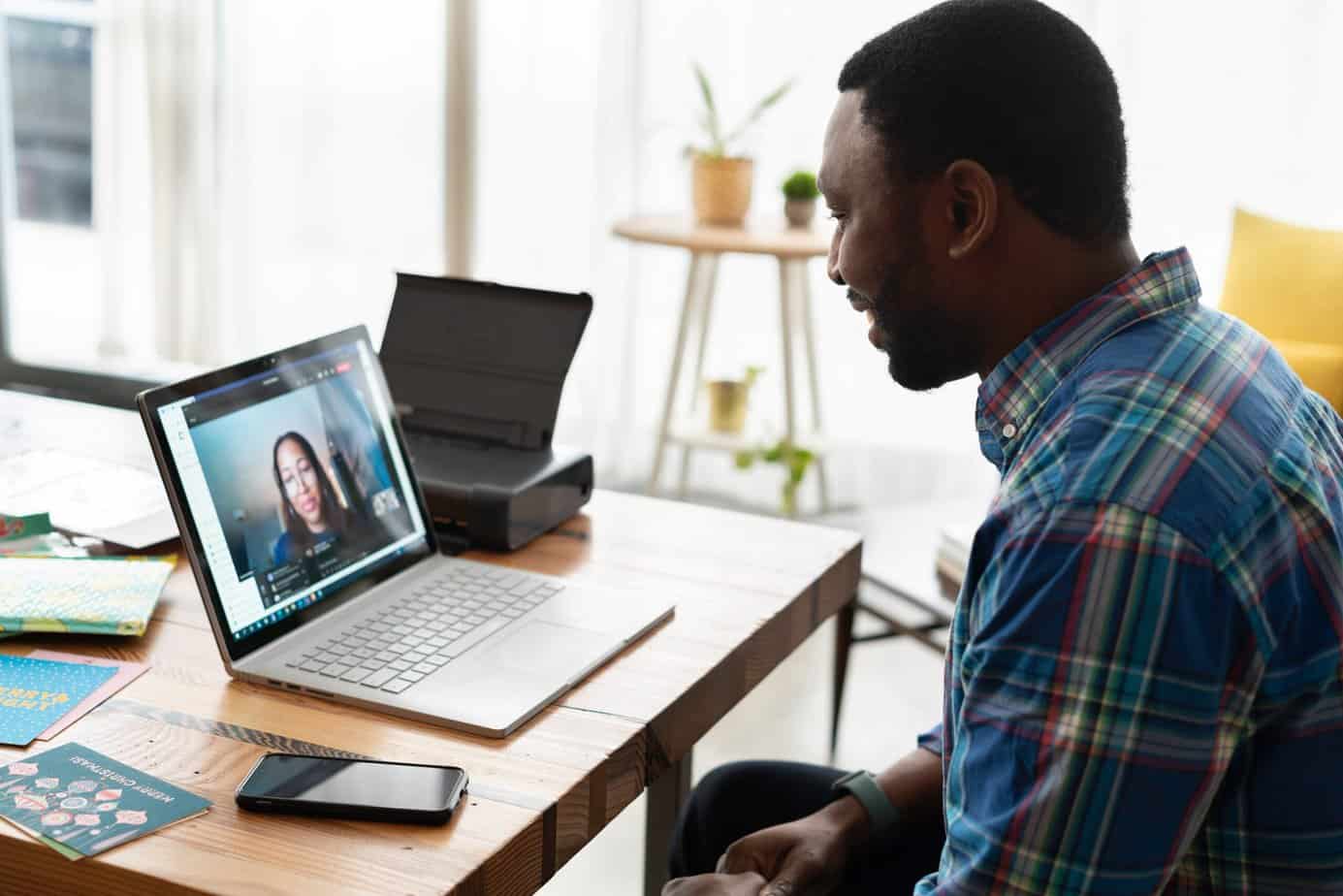 A woman interviewing a man for a job on a video conferencing call at brianvanderwaal.com/interview-tips