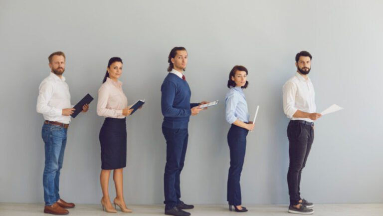 An image at brianvanderwaal.com/personal-profile-for-cv of 5 job applicants with CVs in hands lining up waiting to be interviewed. A strong CV with an effective Personal Profile can help to ensure you are shortlisted.