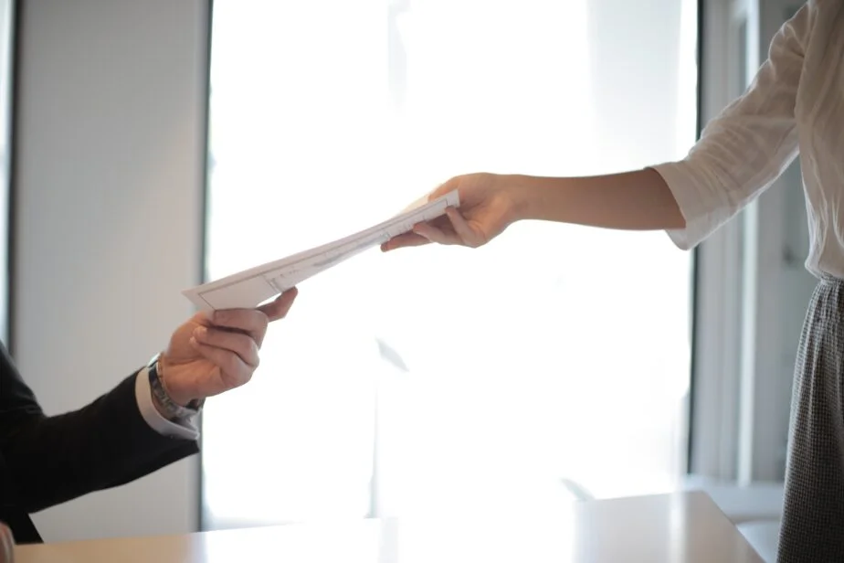 7 Best Cv Writing Services In 2026 1 An Image Of An Applicant Handing His Cv To The Hiring Manager.