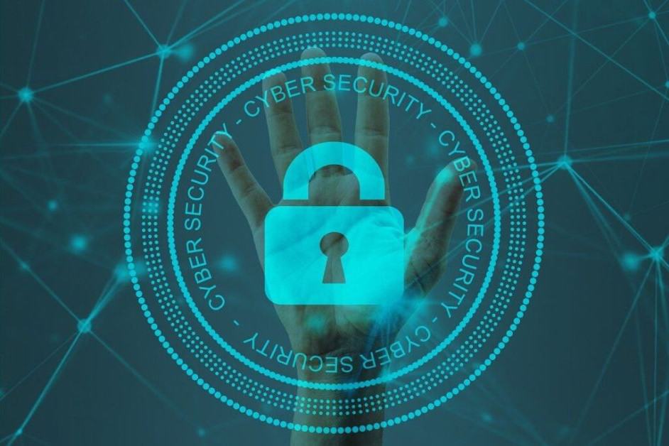 A Cybersecurity image showing a hand and a lock preventing access with the words "Cyber Security" in a circle around the hand.