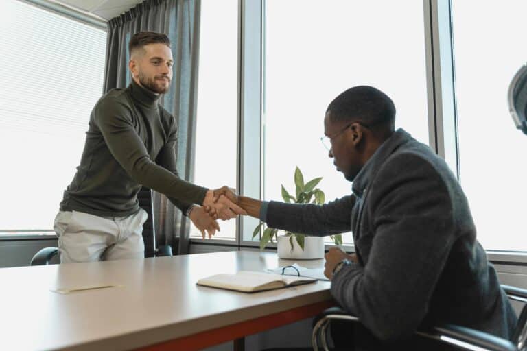 An image of two men shaking hands before a job interview.