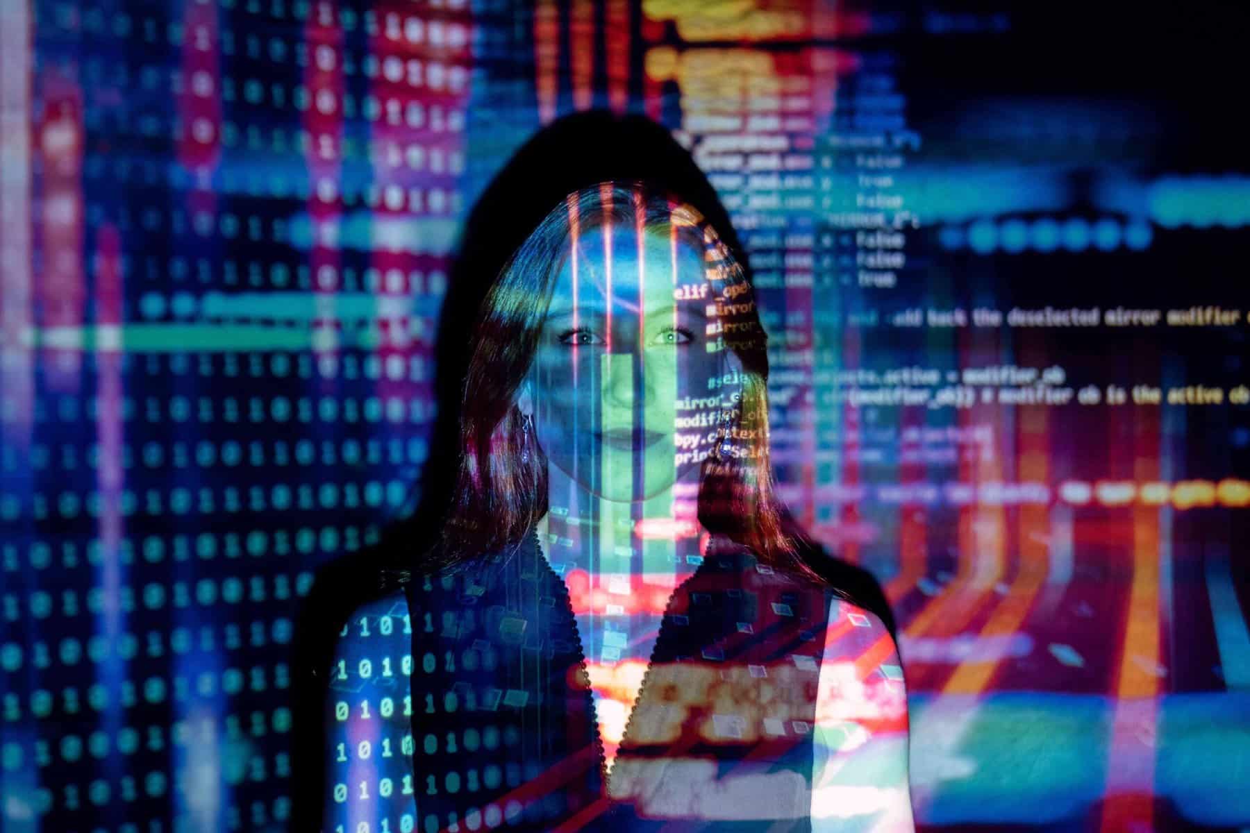 An image with a silhouette of a woman being recruited by the best AI recruitment tools with computer and programming code in the background