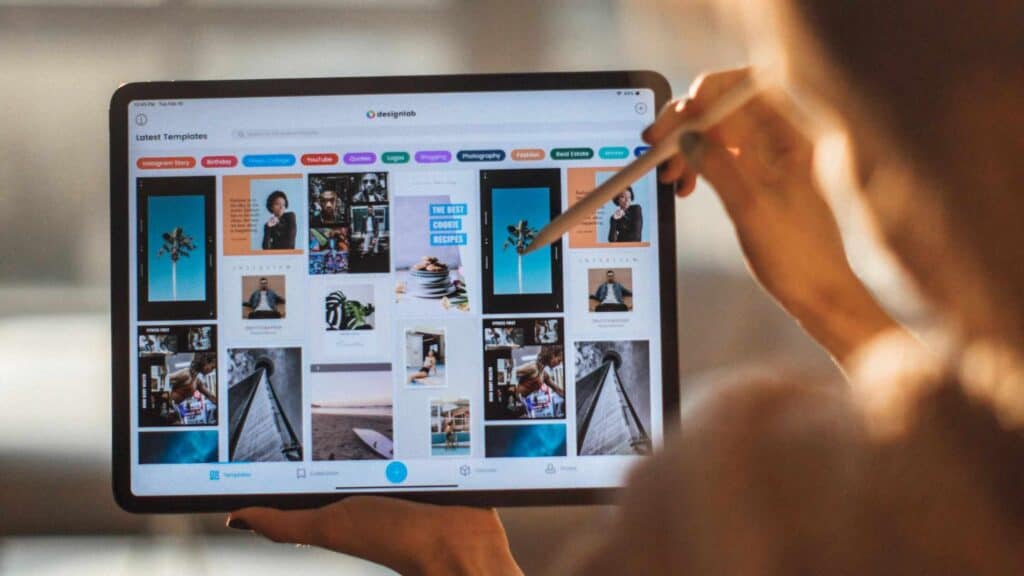 An image of a woman designing her book on a tablet computer.