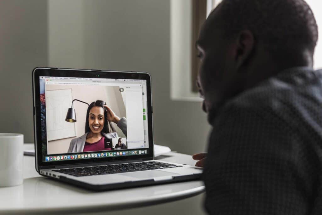 A man and a woman in a video interview.